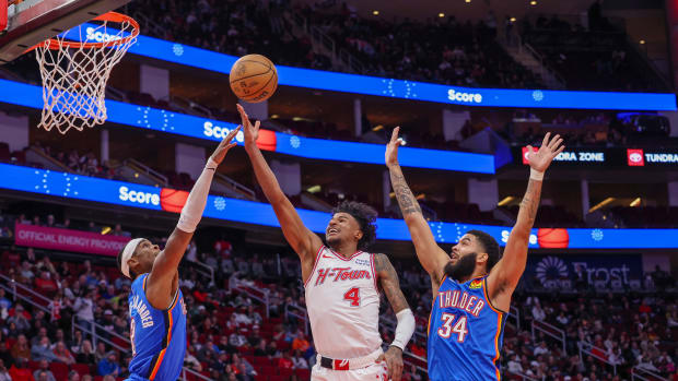 Rockets guard Jalen Green shoots against Oklahoma City Thunder guard Shai Gilgeous-Alexander and forward Kenrich Williams